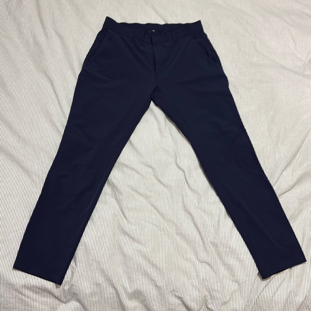 These are 32x32 dress pants by Fabletics. They are navy blue and slim fit.